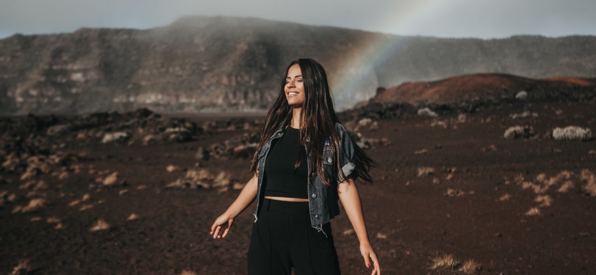 woman with rainbow geting-ready-for-planetary-new-year-Lions-Gate-Mercury-Retrograde-Stock-Photo-by-Candice-Picard