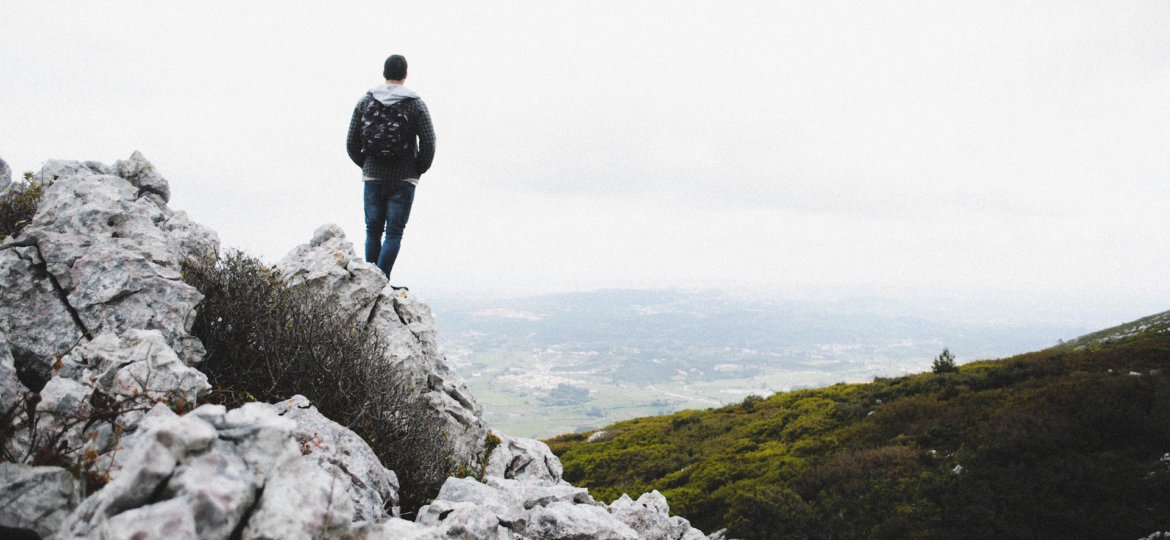 man standing on a peak