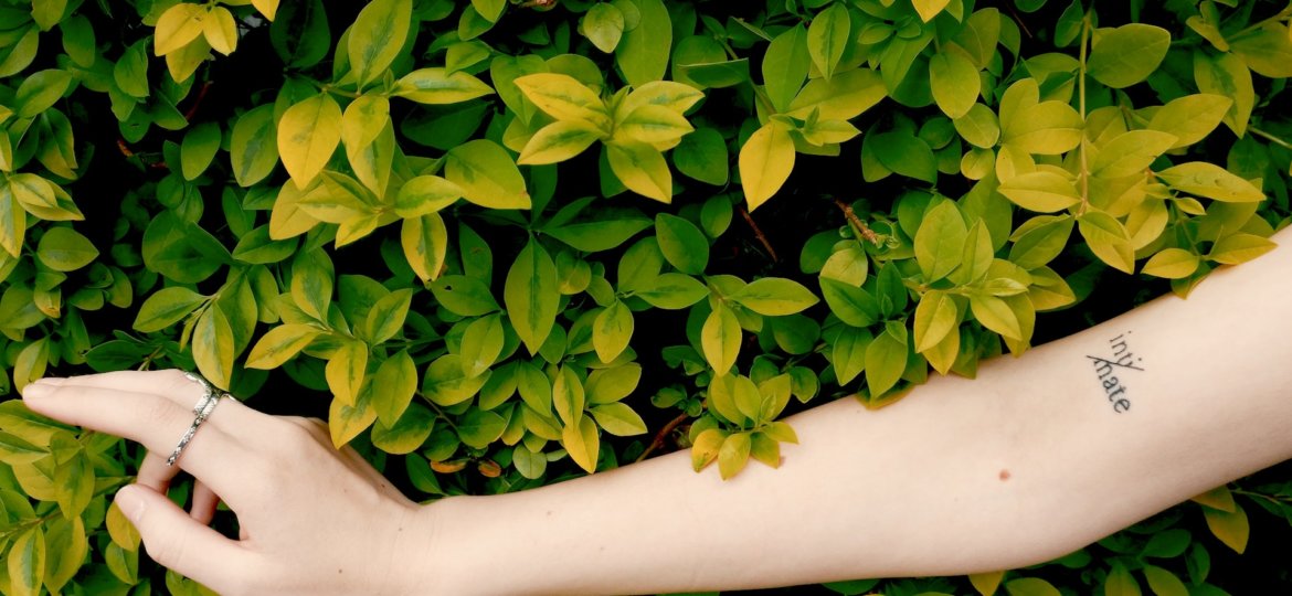 woman's arm in front of leaves innocent intimacy
