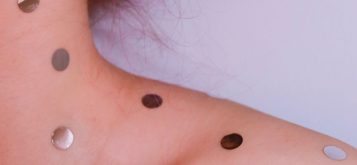 woman with gold dots on her neck and shoulders (dragon's blood wound healing article)